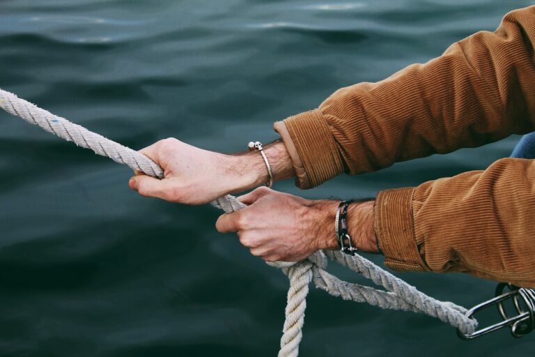 person gripping gray rope