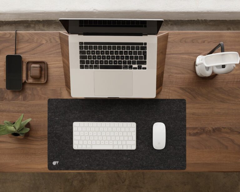 a laptop computer sitting on top of a wooden desk